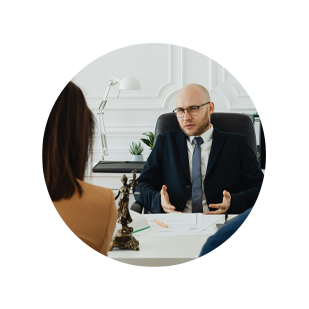 Male lawyer sitting at a desk, talking to a client